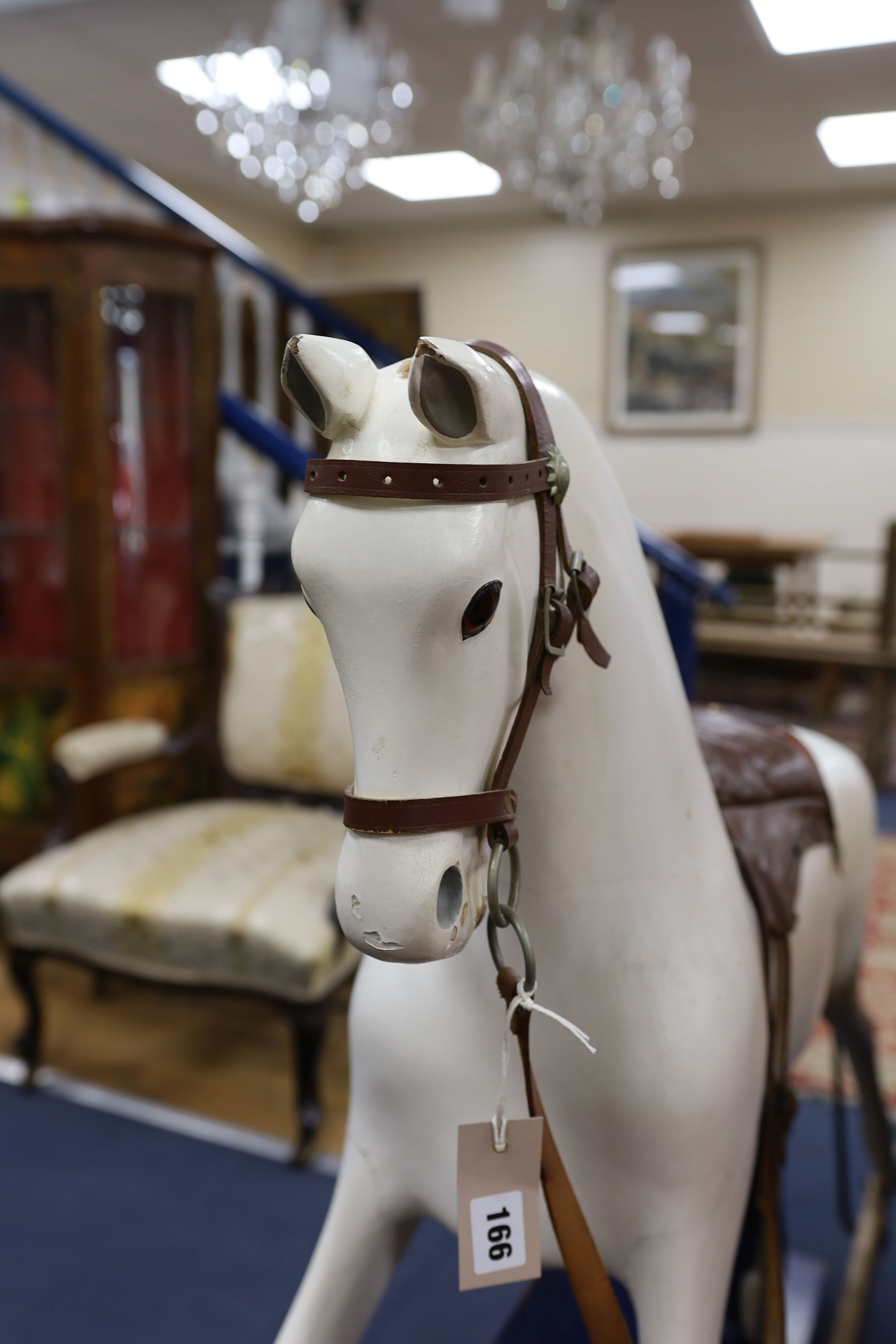 An early 20th century rocking horse on painted safety frame, (re-painted) width 126cm, height 114cm